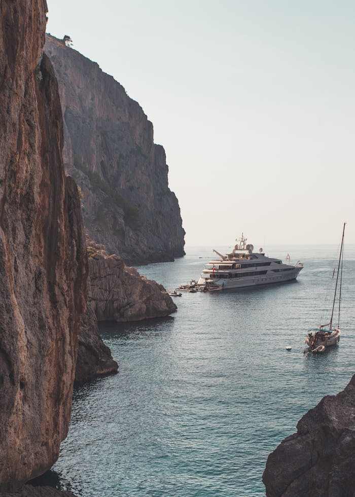 Luxury yacht anchored amidst the stunning cliffs of Escorca, Palma de Mallorca. Perfect vacation escape.